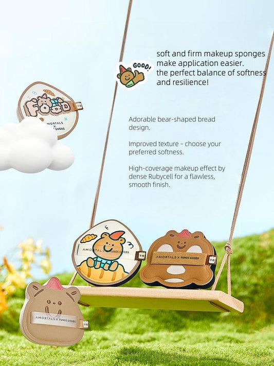 Bear-shaped makeup puffs hanging from a stand, including teardrop and bear-face styles