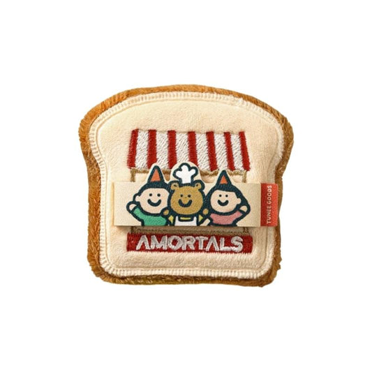 Toast-shaped powder puff with tan velvet and stitched cartoon patch label