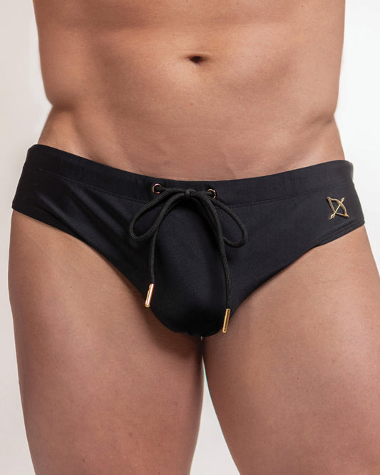 Midnight black swim brief with drawstring front and gold logo patch