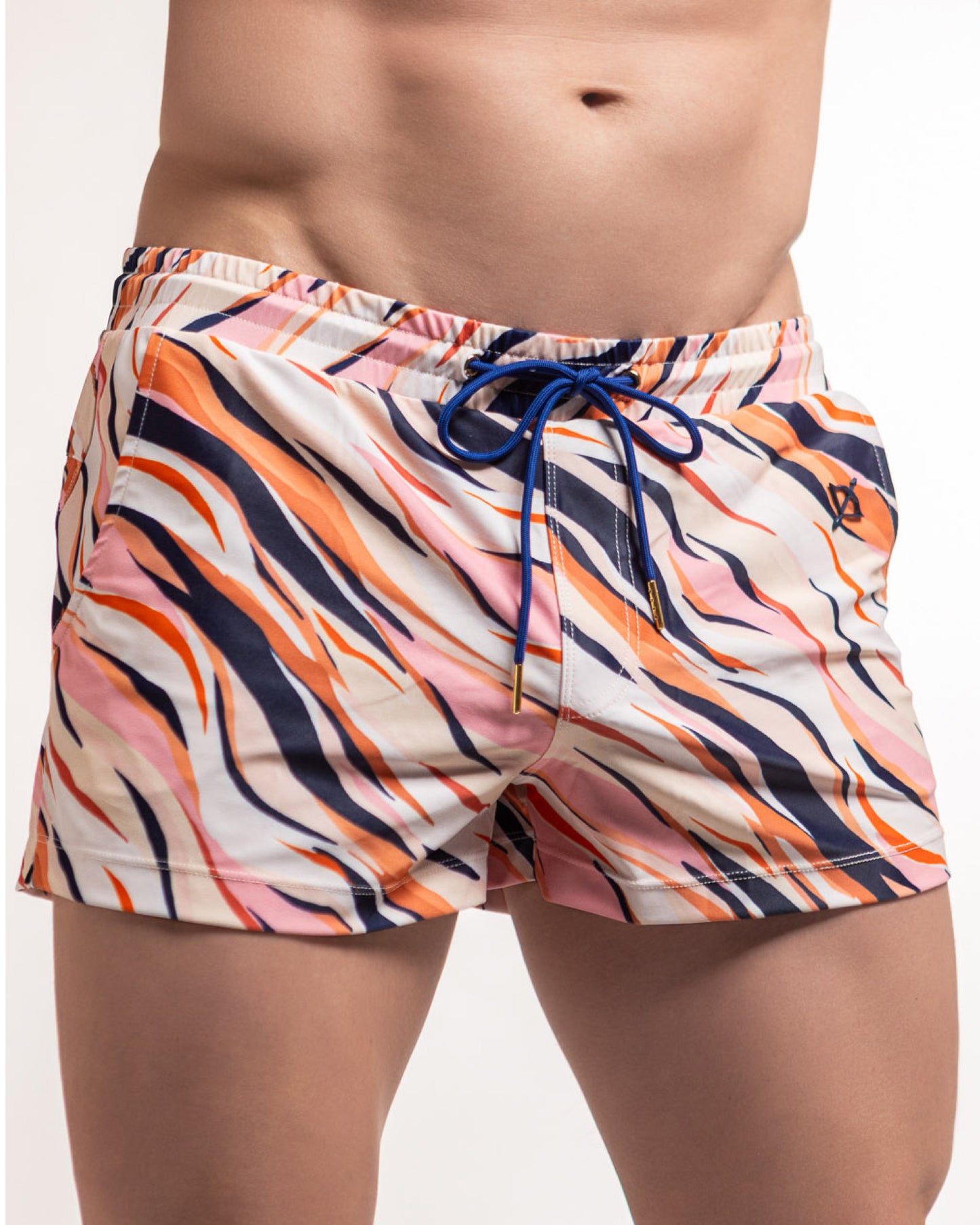 Tiger-print swim shorts in pink, navy, and orange with blue drawstring