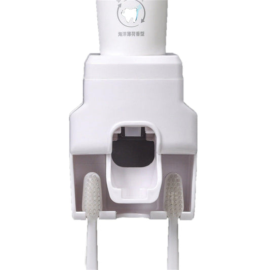 White wall-mounted automatic toothpaste dispenser with squeeze slot and toothbrush holder
