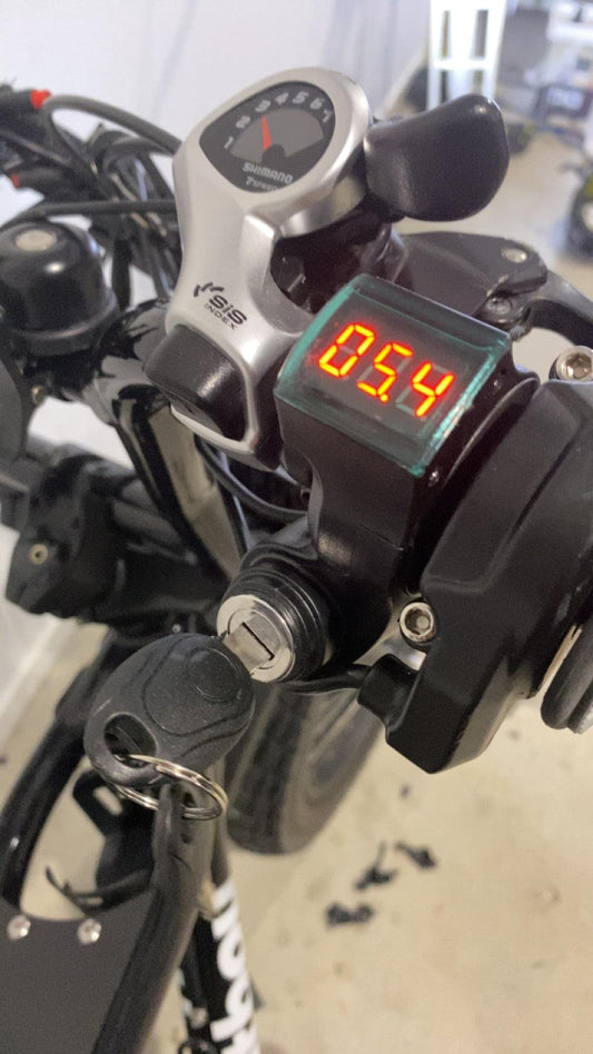 Motorcycle key ignition switch with blue digital display on handlebar