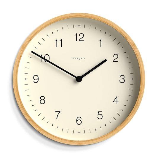 Close-up of round wall clock face with black hands and hour numerals