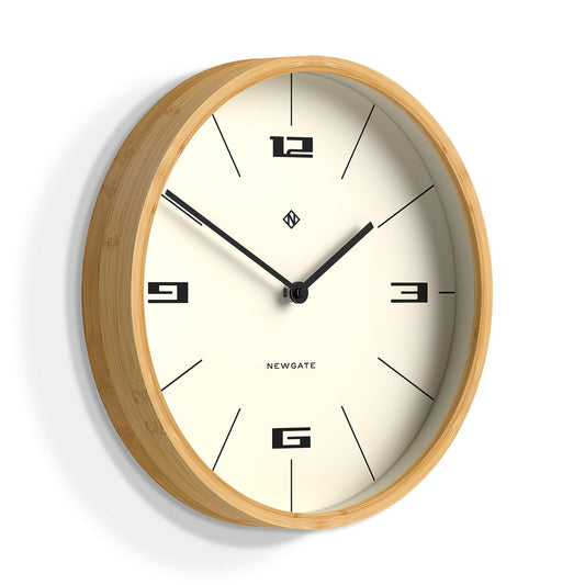Wood-framed wall clock with cream dial, black Roman-style numerals, and black hands