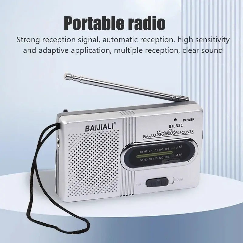 White AM/FM portable radio with speaker grille, tuning dial, and black lanyard strap.