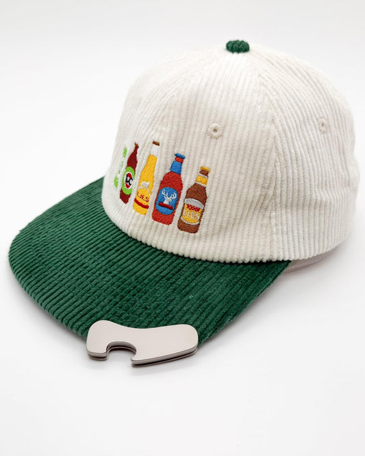 Cream-and-green cord hat with bottle graphic patch and silver bottle opener clip