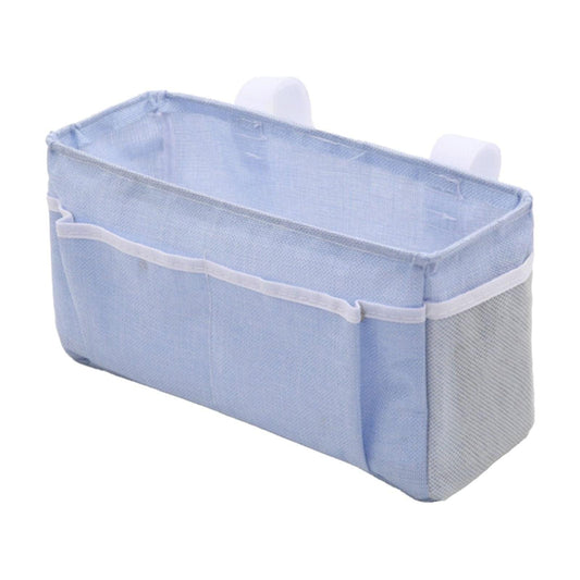 Light blue bedside storage caddy with white trim and open compartments for small items