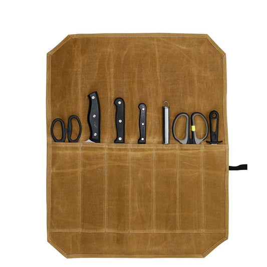 Beige knife roll bag with stitched pockets holding knives and scissors