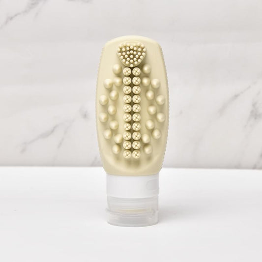 Beige silicone refillable squeeze bottle with built-in brush head