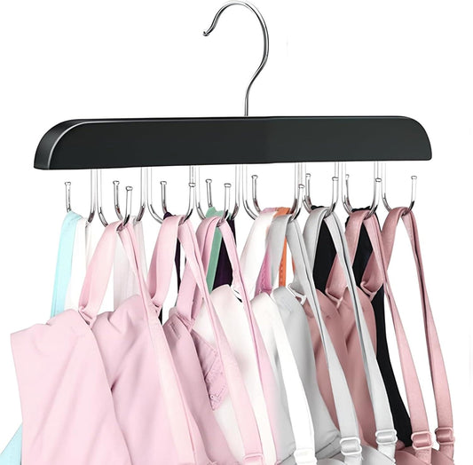 Black belt organizer hanger with curved top and multiple metal hooks holding belts