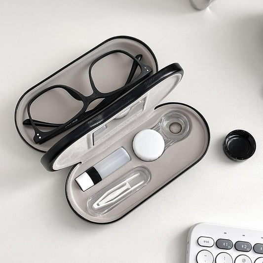 Eyewear case open with mirror, lens tools, and eyeglasses inside