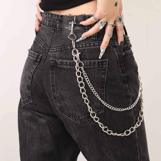 Black denim pants with double silver chain across hip and one dangling chain