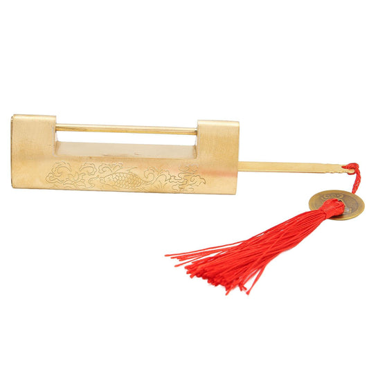 Brass horizontal padlock with engraved panel, red tassel cord, and coin charm