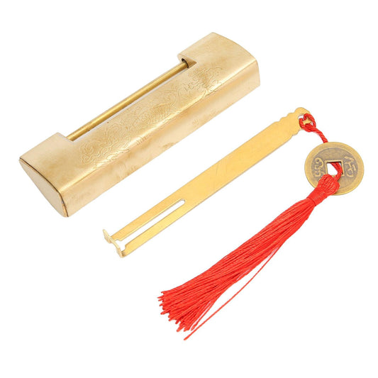 Brass padlock with rectangular housing, separate shackle piece, and red tassel coin charm