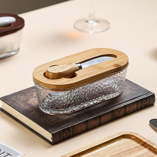 Glass butter keeper with clear textured base, bamboo lid and butter spreader