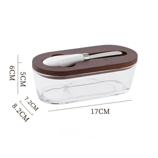 Glass butter dish with dark wood lid and built-in spreader, sealed clear container
