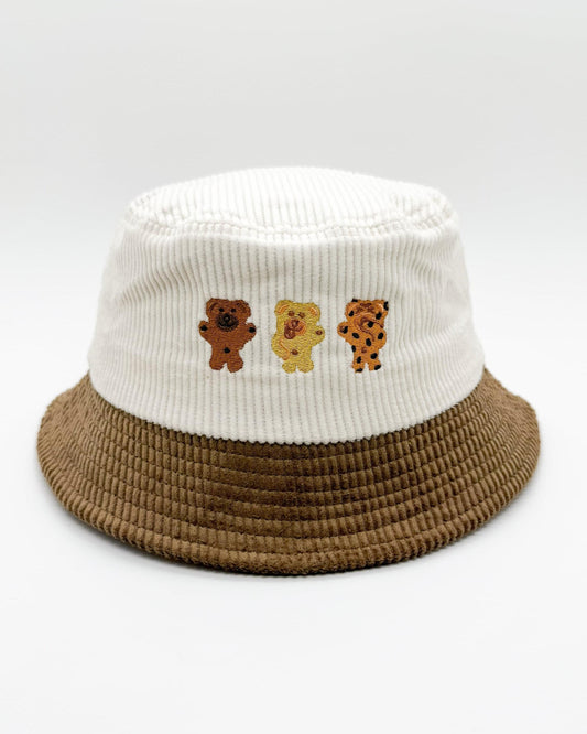 Two-tone bear bucket hat with white crown, brown brim, and three bear patches
