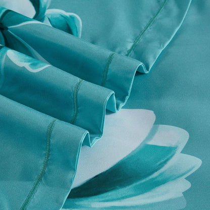 Turquoise quilt cover fabric with stitched seam and large butterfly print detail