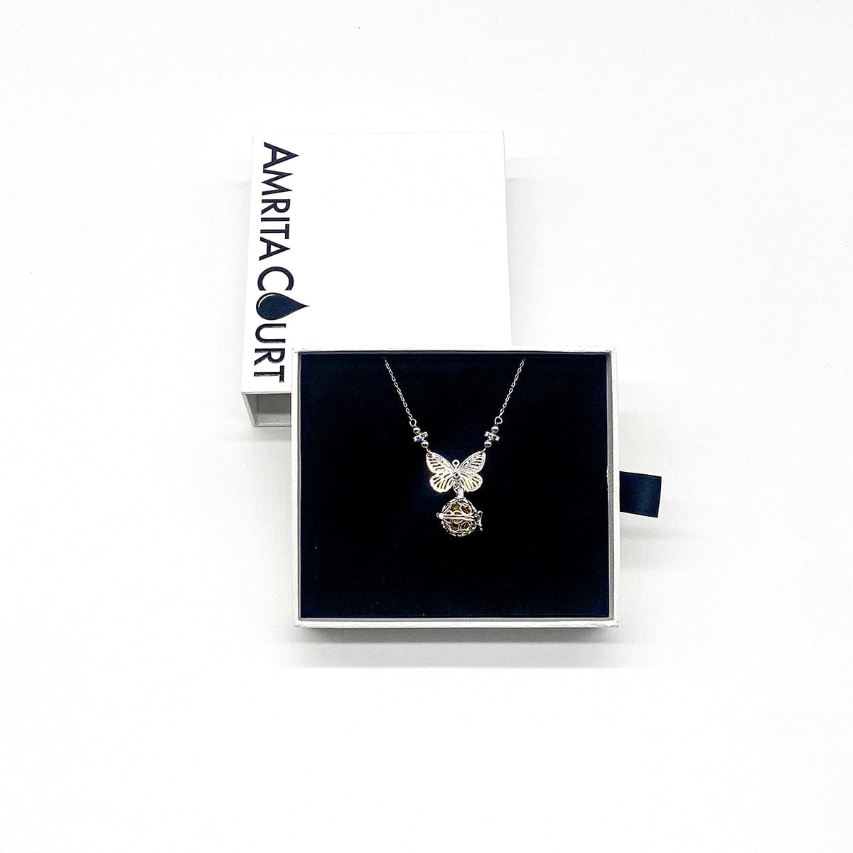 Silver-tone butterfly pendant necklace displayed in a gift box