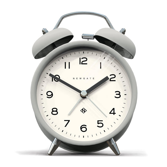 Matte grey twin-bell alarm clock with cream dial and Newgate logo, metal legs
