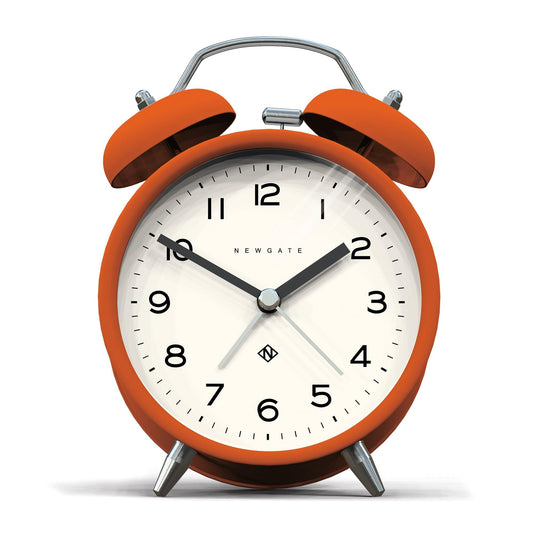 Orange matte twin-bell alarm clock with silver handle and legs, white face with black numerals