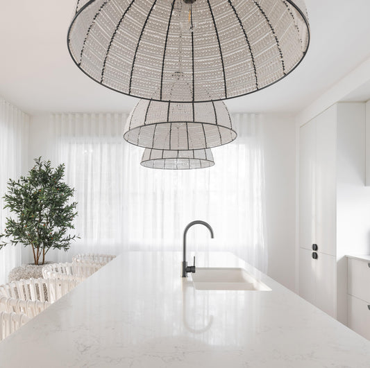Beaded dome pendant light showing black ribs and white bead panels from below
