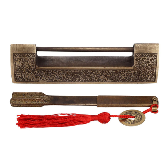 Antique brass horizontal padlock with floral scroll pattern and included red tassel keychain.