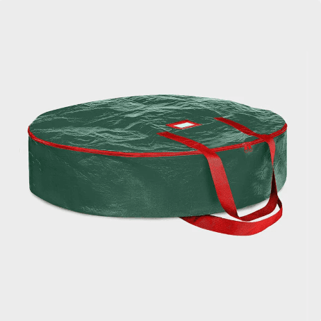 Round green wreath storage bag with red zipper track and red carry handles