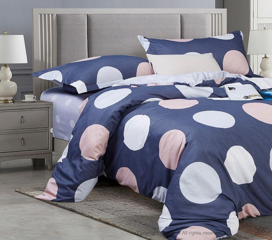 Super king duvet cover set with navy and blush large circle pattern on bed