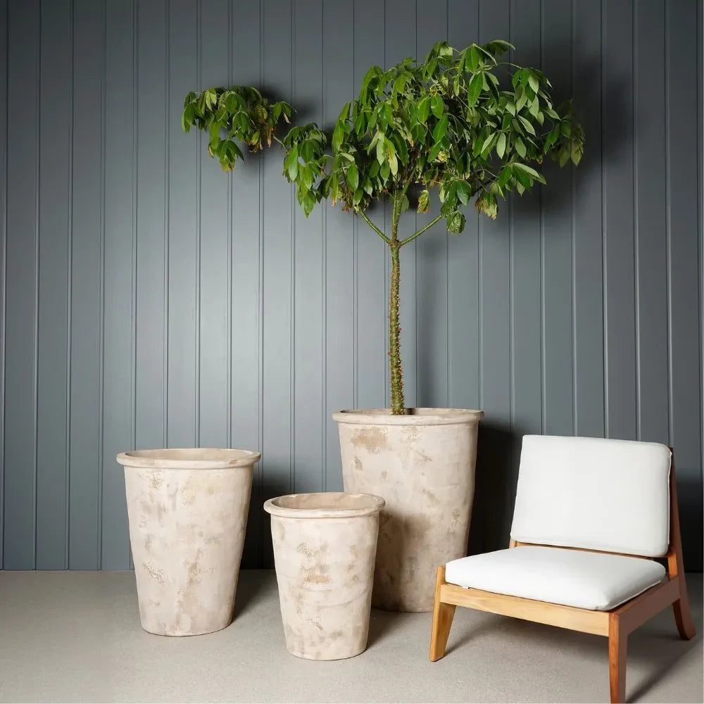 Conical planter pots in light speckled finish with small tree and seating nearby