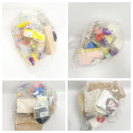 Assorted lucky-dip toys and accessories in clear plastic bags, mixed colors