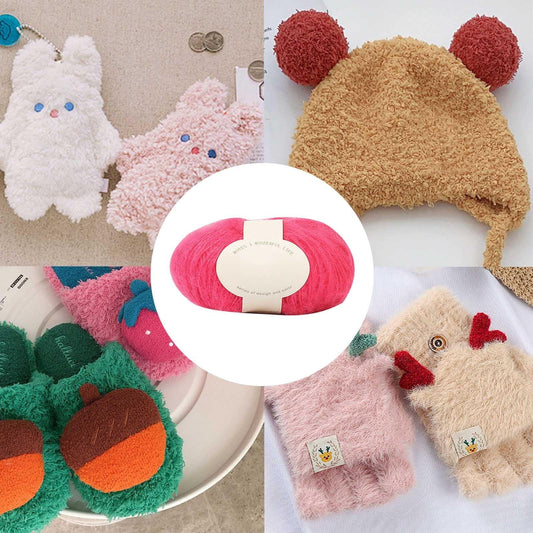 Pink mohair yarn skein displayed with plush toys around it