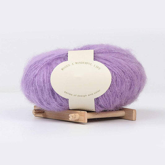 Lilac purple yarn skein on small wooden stand with cream product label