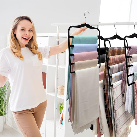 3-pack velvet hanger organizer displaying stacked folded fabrics on black multi-bar hooks