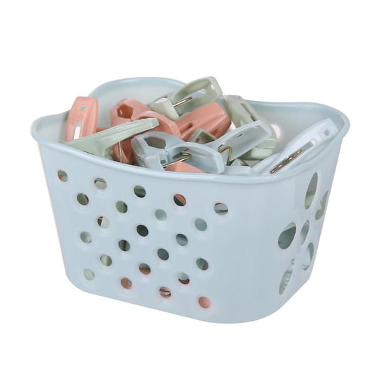 Plastic clothes pegs in a light blue storage basket, assorted pastel colors