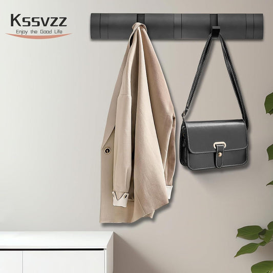 Black wall-mounted coat rack with retractable hooks holding coats and handbags