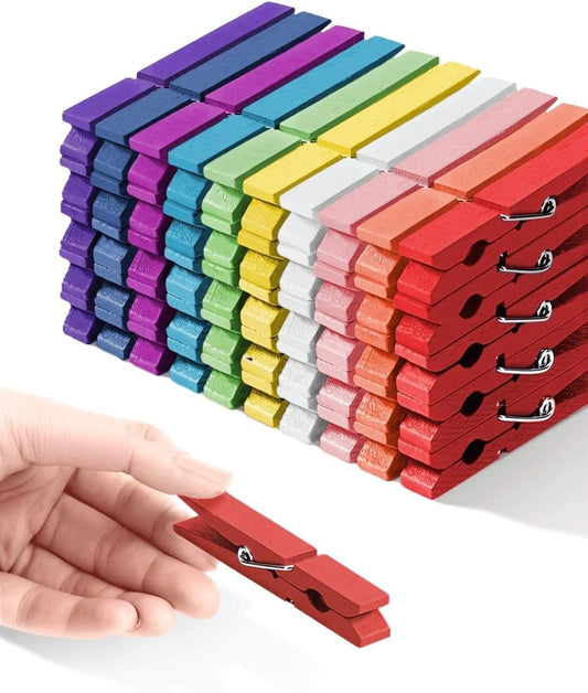 Rainbow wooden clothespins with metal springs, neatly stacked in multiple colors