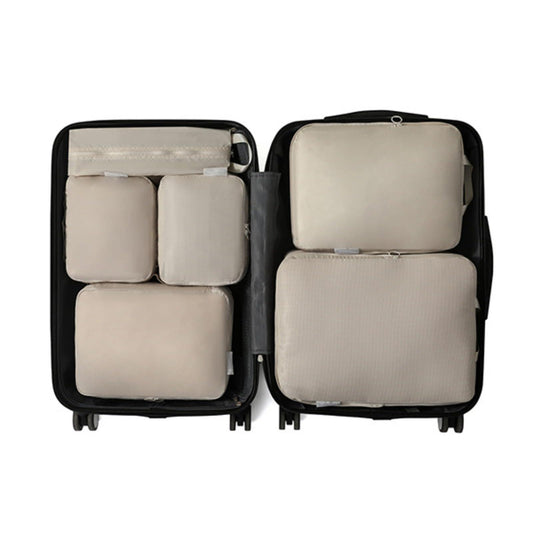 Beige compression packing cubes set with double zippers, organized in a suitcase
