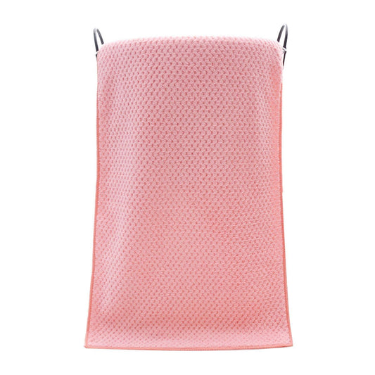 Pink bath towel with textured velvet loops at top corners