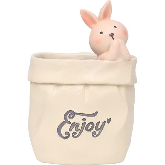 Cream resin paper-bag pen holder with bunny figurine on the rim