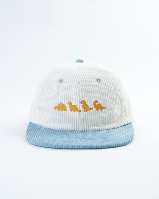 White striped knit hat with light blue brim and yellow dinosaur patch