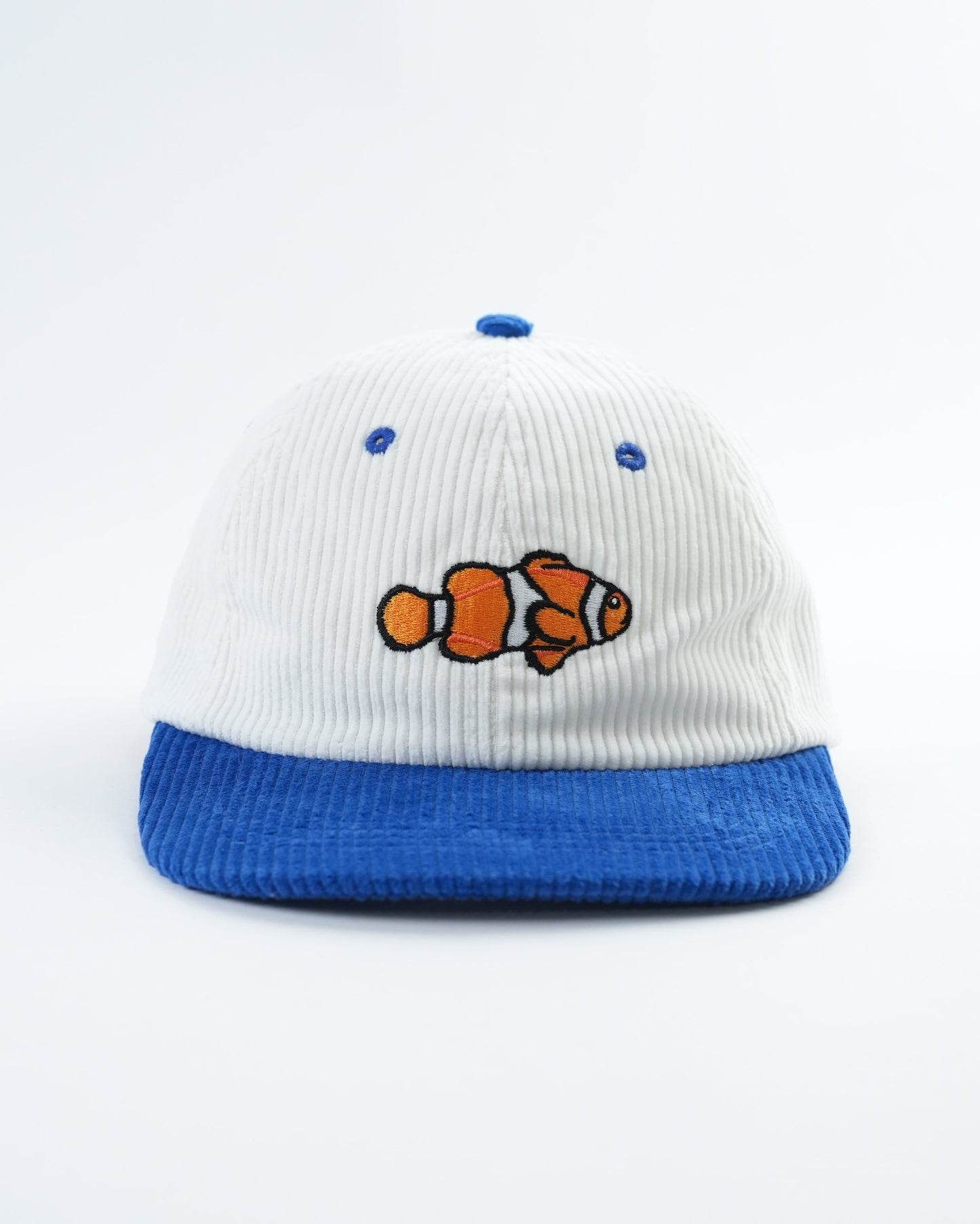 White and blue baseball cap with clownfish patch and blue embroidered dots