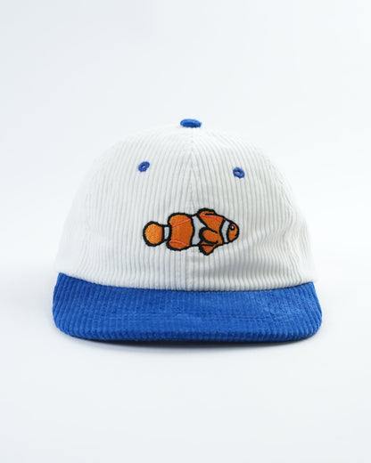 White and blue baseball cap with clownfish patch and blue embroidered dots