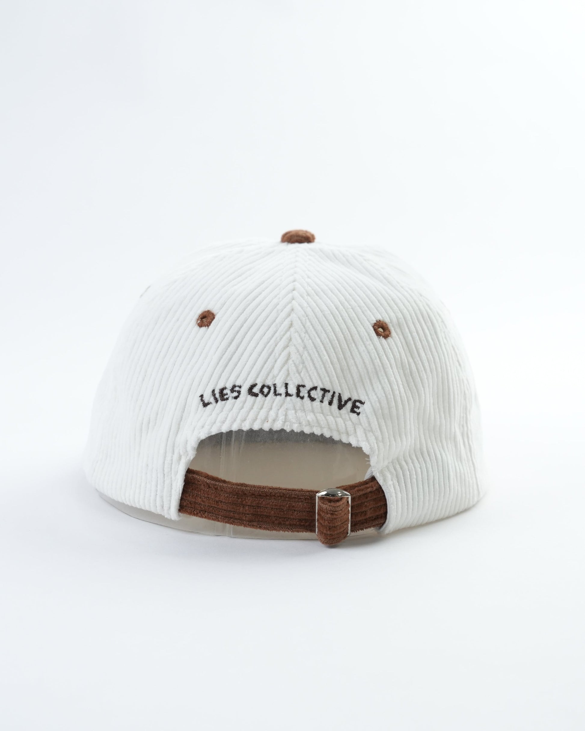 White striped mini lid back with 'LIES COLLECTIVE' text and brown adjustable strap