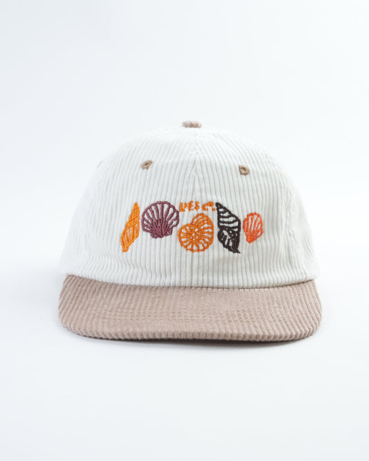 White ribbed baseball cap with beige brim and seashell embroidery front