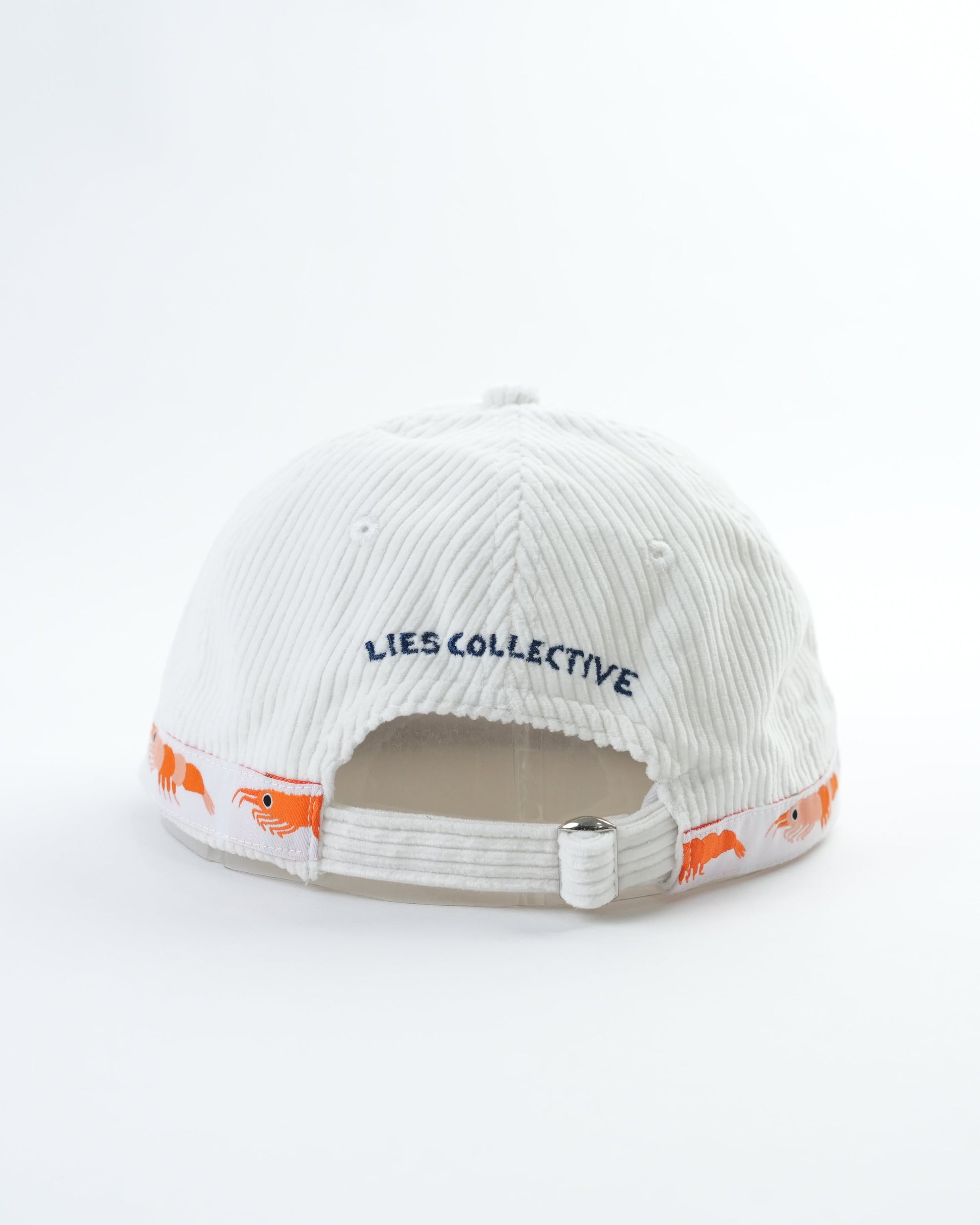 White cap interior view with LIES COLLECTIVE text and orange fish graphics