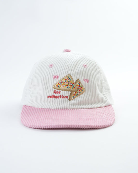 Kids fairy bread cap with white ribbed fabric, pink brim, and embroidered cupcake logo