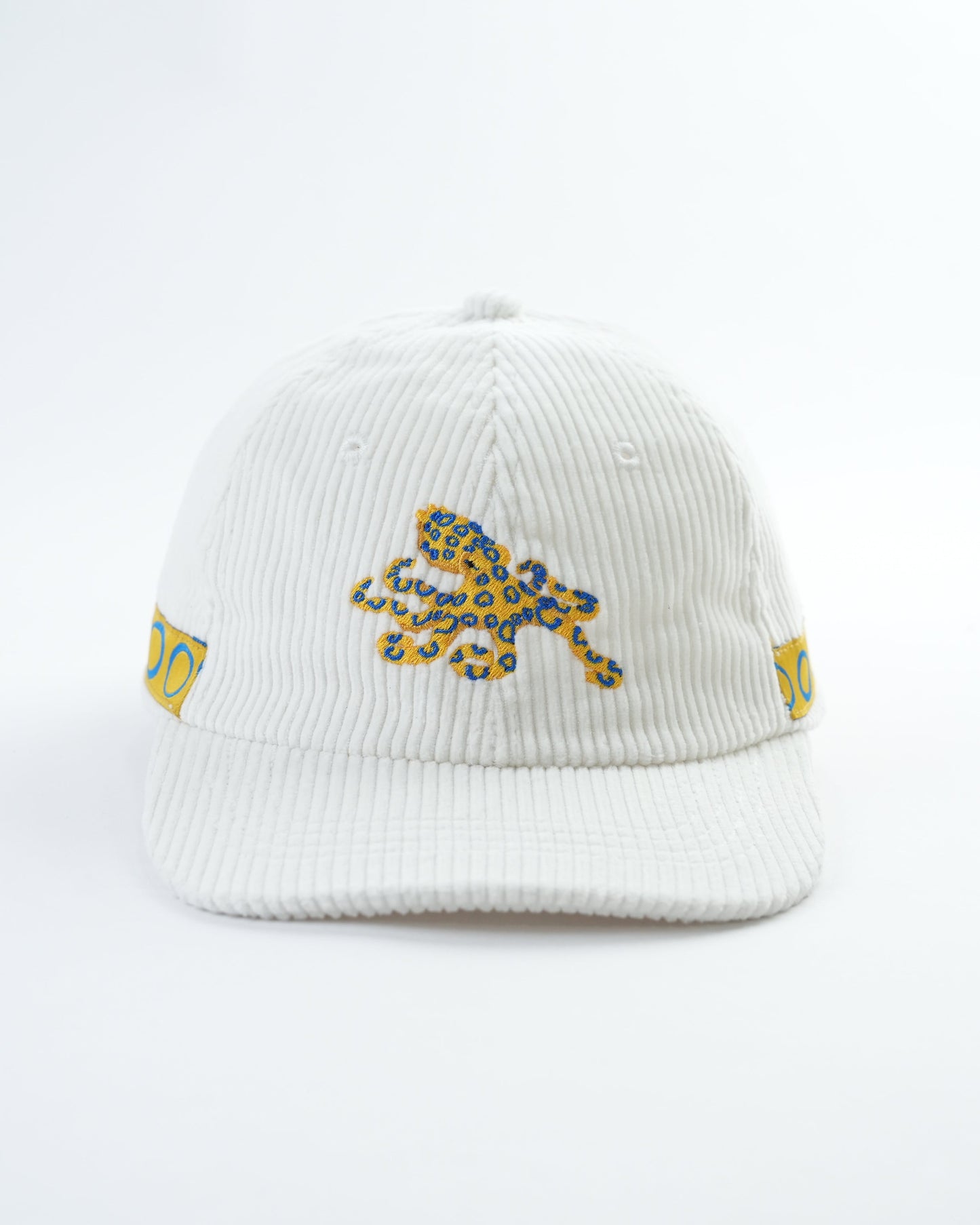 White ribbed cap with blue-yellow octopus patch