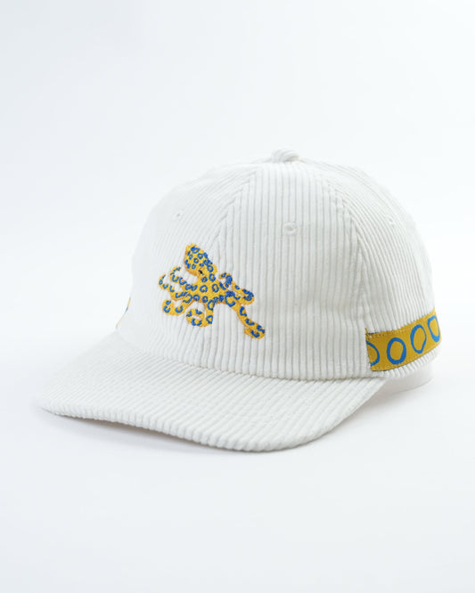 White ribbed cap with octopus patch and blue side text