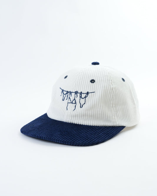 White pinstripe baseball cap with navy brim and embroidered graphic front